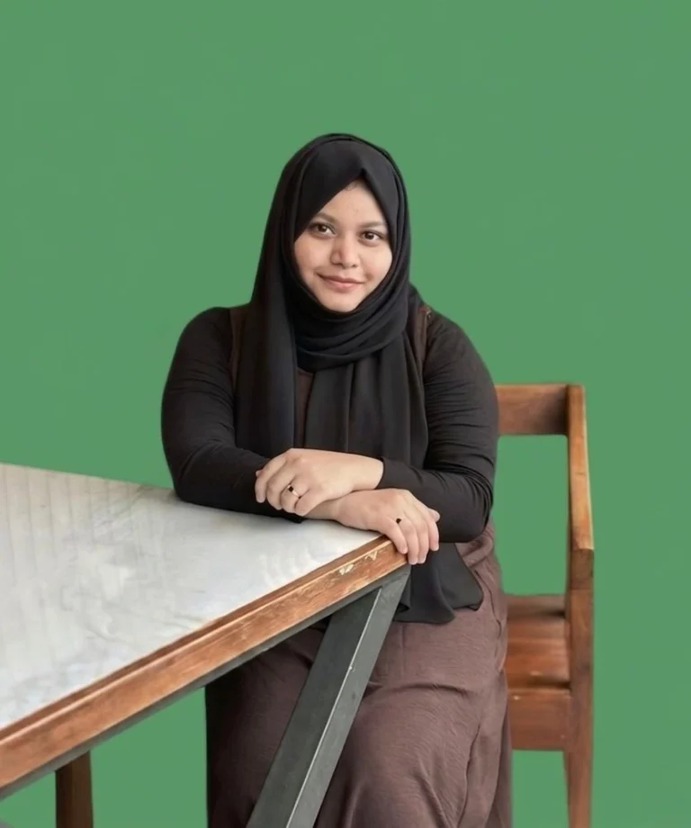 A professional headshot of a freelance Seo expert in Kerala sitting at a desk.